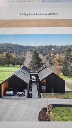 an aerial view of a house with two cars parked in the driveway and on the road