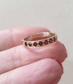 Solid gold Garnet half eternity ring, Garnet stacking ring, stacking gemstone rings, January birthstone ring, Garnet gold ring Solid gold, handmade half eternity stacking ring, stoned with 7 beautiful deep red gemstones. This multistone ring is beautiful alone or stacked together with other rings and is colorful and pretty on your finger. The ring is available in 9k or 14k solid gold- yellow, white or rose. It is also available in nickel free, 14 karat gold plating over brass or silver and in so Dainty Stackable Ruby Ring For Anniversary, Heirloom Stackable Eternity Band As Gift, Red Engagement Ring, January Birthstone Rings, The Bling Ring, Dope Jewelry, Etsy Gold Ring, Garnet Jewelry, Half Eternity Ring