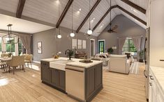 a large open concept kitchen and living room in a house with wood flooring, vaulted ceilings, white walls, and wooden floors