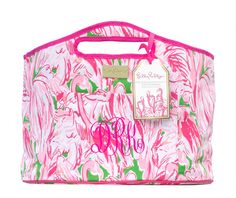 a pink and green floral print bag on a white background with a tag attached to it