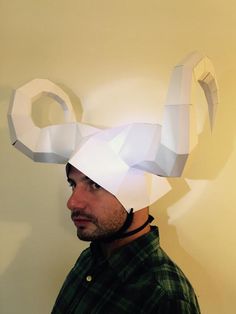 a man wearing a paper hat with the letter q on it