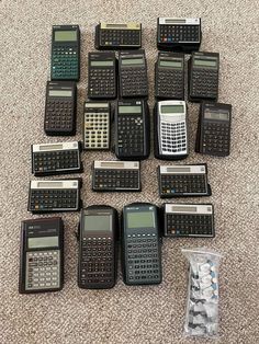 there are many calculators on the floor next to each other, including one that has a cell phone in it