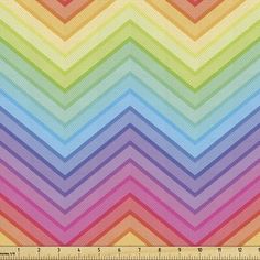 a rainbow colored chevroned fabric with a ruler on the bottom and bottom side