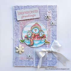 a christmas card with snowflakes and an ornament on the front,