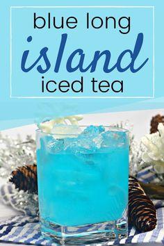 blue long island iced tea in a glass with ice and pine cones on the side