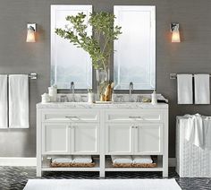 a white bathroom with two sinks and mirrors