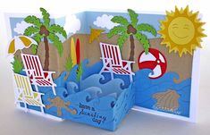 a pop up card with chairs and umbrellas on the beach