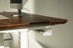 a computer monitor sitting on top of a wooden desk