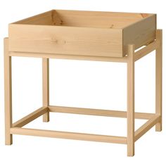 a wooden table with an open drawer on the top and bottom section, in front of a white background