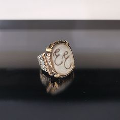 "✓ Personalized Hair Locket Initial Ring For Men. Our Solid 925 Sterling Silver ring with; %100 hand crafted, gold workmanship is specially produced for you, Jewelry made with love for your special occasions. ---● R I N G ∙ D E T A I L S ●--- * The Case Of The Ring is SOLID 925 STERLING SILVER. * The upper part of the ring is made of UV stable resin. And your hair will be safe in it. * We create letters/designs by hand crafted by separating your hair into strands. * The shapes of the letters/des Luxury Etched Ring Jewelry, Wedding Initial Ring In White Sterling Silver, Elegant White Initial Ring With Engraving, Antique Etched Ring Jewelry, Oval Sterling Silver Engraved Ring, Luxury Silver Rings With Etched Details, Antique Etched Jewelry Ring, Elegant White Initial Ring Engraved, Elegant White Engraved Initial Ring