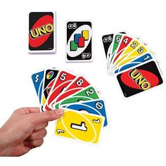 a hand is holding several uno card game pieces