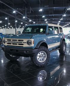 a large blue truck parked inside of a building