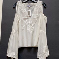 Nwt Intermix Cold Shoulder V-Neck Embroidered Blouse Sz S . Est. Retail $265.00 Exquisite Beautiful Fabric And Embroideries ! Very Classy And Feminine Cut Out Shoulder ! Bust: 35" Waist: 35" Length: 22.25" Fabric: 70% Cotton, 30% Silk; Lining 70% Cotton, 30% Silk; Embellishment 100% Polyester Condition : New With Tag, Prestine Final Sale , No Return Elegant V-neck Blouse With Floral Embroidery, Chic White V-neck Embroidered Top, Chic Fitted V-neck Embroidered Top, Chic V-neck Fitted Embroidered Top, Chic White Embroidered V-neck Top, Chic White Blouse With Embroidered Sleeves, Chic White Tops With Embroidered Sleeves, Elegant Summer Blouse With Embroidered Neckline, Spring V-neck Top With Embroidered Sleeves