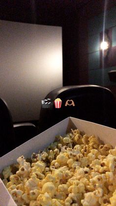 a box filled with popcorn sitting on top of a table