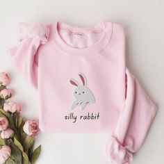 Silly Rabbit Sweatshirt, Embroidered Rabbit Crewneck Sweatshirt, Silly Rabbit Shirt, Funny Sweatshirt, Funny Embroidered Shirt This embroidered silly rabbit crewneck sweatshirt is everything. Perfect to tell everyone that you're a silly rabbit. Please let me know if you would like extended sizing (3X-5X). I have certain size/color combinations available! ✨ 50% cotton, 50% polyester ✨ Pre-shrunk ✨ Classic fit Care: Machine wash: warm (max 40C or 105F) Tumble dry: low Do not iron directly on the print About me: My name is Sarah and I am a graduate student and music teacher! I run this small business myself and enjoy creating fun designs in my free time for some extra cash. I hope that you enjoy these designs as gifts for others or even yourself! REFUNDS AND EXCHANGES All items are made to or Silly Rabbit, Animal Sweater, Funny Bunnies, Funny Sweatshirts, Pink Sweatshirt, Embroidered Shirt, Color Combinations, Sweat Shirt, Crew Neck Sweatshirt