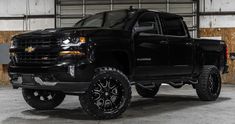 a black truck is parked in a garage