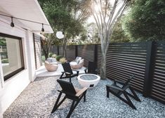 an outdoor patio with black and white furniture