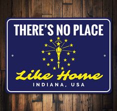 there's no place like home in indiana, usa sign on wooden wall with wood paneling