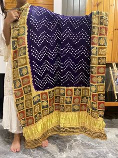 A Beautiful Gaji silk dupatta with the combination of two different crafts Bandhani and Ajrakh. Bandhani is a traditional form of tie-dye native to Gujarat and Rajasthan. It is a highly skilled technique where the fabric is elaborately tied & dipped in dyes and threads are removed leaving behind tiny circles characteristic of Bandhani. Ajrakh derived from the Persian to mean Indigo, a color hard to miss among the geometric and floral patterns of Ajrakh work. Ajrakh is a block-printing technique Blue Bohemian Banarasi Silk Dupatta, Festive Multicolor Bandhani Print Dupatta, Festive Bollywood Dupatta With Block Print, Festive Bollywood Style Dupatta With Block Print, Bollywood Style Festive Dupatta With Block Print, Bohemian Bandhani Traditional Wear For Ceremonies, Festive Bollywood Block Print Dupatta, Bollywood Block Print Dupatta For Navratri, Bollywood Style Block Print Dupatta