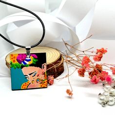 This stunning pendant-necklace features a hand painted portrait of Mexican icon Frida Kahlo that is sure to make a statement. Adorned with colorful floral designs, this mini masterpiece is a must-have accessory for the fashion-forward fridalover. Each piece is lovingly hand painted using high quality acrylic paint and protected with a special glossy coating, so you can wear it with confidence all spring and summer long. Lightweight and one of a kind, it's the perfect gift for any special person in your life. DETAILS: We used three (3) waxed cotton necklace cords which are approximately 20 inch long by 1.5mm each with Lobster Claw Clasps. Material: Wood This unique pendant is 1 1/4 inch x 1 1/4 inch. ______________________________________ • GET IT FAST!Get it fast! Ready to ship on 1 to 3 b Cotton Necklace, Wood Pendant, White Gift Boxes, Unique Pendant, Waxed Cotton, Special Person, Floral Designs, Material Wood, Lobster Claw