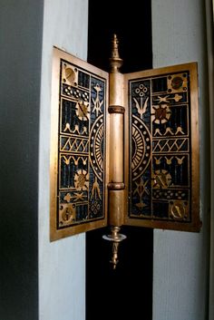 an open door with a fancy design on the front and back side, in gold