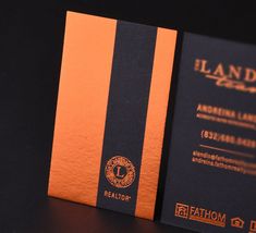 an orange and black business card sitting on top of a table