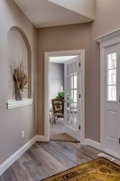 an empty entry way leading to a dining room