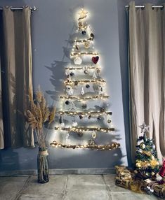 a white christmas tree with lights and ornaments