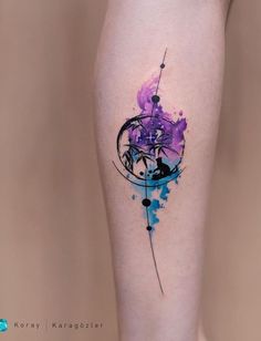 a woman's leg with a purple and blue tattoo design on the side of her thigh