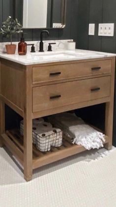 a bathroom with a sink, mirror and toiletries on the counter in front of it