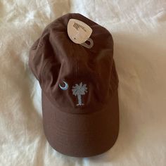 Never Worn. Brown With Blue Embroidery. Casual Brown Hat With Embroidered Logo, Packable Sun Hat, Fluffy Bucket Hat, Floral Bucket Hat, Running Cap, Flat Bill Hats, Rancher Hat, Black Bow Tie, Feather Hat