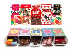 assorted chocolate candies are displayed in boxes