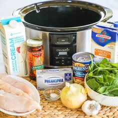 the ingredients for this meal are displayed in front of an instant pressure cooker, including chicken and vegetables