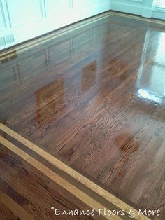 an empty room with wood floors and white trim