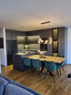 a modern kitchen and dining room with wood flooring