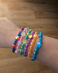 a person's arm with several bracelets on it