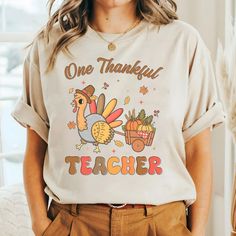 Thanksgiving Teacher Shirts, Fall Teacher Shirts, Teacher Tshirt, Teacher Fall Shirt, One Thankful Teacher Tees, Cute Teacher T Shirt We've got all this and more: - Tshirt material: cotton, polyester - Sweatshirt material: cotton, polyester - Hoodie material: fleece fabric, heavy blend Production and Shipping - Processing Time: 3-5 business days - Shipping time (US): 3-5 business days - Shipping time (WW): 10-15 business days Note - Manual measurement may exist a 1-2cm difference - Actual colors may be slightly different from the image due to different monitor and light effects. - Please contact our support team for detailed information. - No returns or exchanges unless there's a defect or our mistake Thank you for choosing my store! Funny Cotton Tops For Fall, Thanksgiving Teacher Shirts, Fall Teacher Shirts, Teacher Tees, Hoodie Material, Fall Shirt, Teacher Tshirts, Fall Shirts, Shirt Ideas