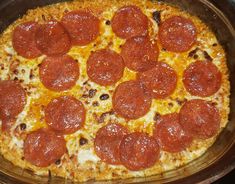 a pepperoni pizza sitting in a pan on top of a stove burner and ready to be eaten