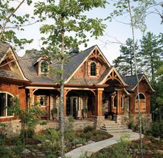 this is an image of a house in the country style with stone and wood accents