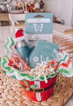 a basket filled with items sitting on top of a table next to a christmas tree