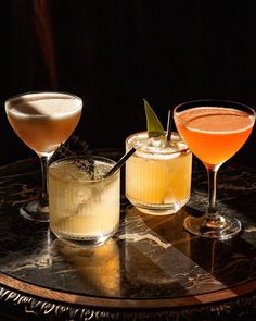 three different types of cocktails sitting on a table