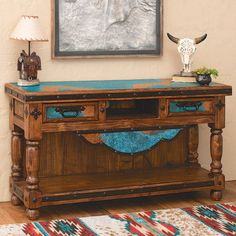 a wooden table with two drawers and a cow's head on the wall above it