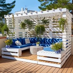 an outdoor living area with blue and white furniture