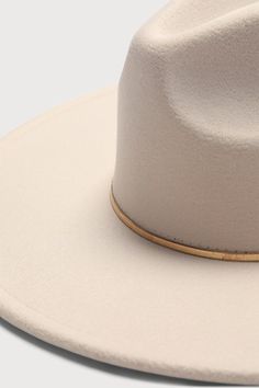 We're saying ""yeehaw"" to style and hitting the road in the Lulus Room to Roam-ance Ivory Fedora Hat! Sturdy felt shapes this stylish hat that features a structured wide brim, teardrop-shaped crown, and a slender, gold-toned metal band that adds a chic finish. 3. 75" Hard Brim. 23" Interior Circumference With Internal Drawstring. Crown Measures 5" Tall. 90% Polyester, 10% Alloy. Imported. Lulus | Room to Roam-ance Ivory Fedora Hat. Felt Shapes, 75 Hard, Wide Brim Fedora, Stylish Hats, Metal Band, Fedora Hat, Metal Bands, Wide Brimmed, Gold Tone Metal