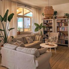 a living room filled with furniture and a large window