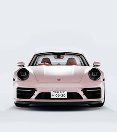 the front view of a pink porsche sports car