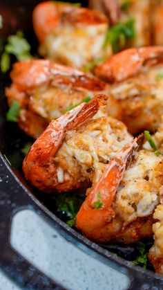 cooked shrimp in a pan with parsley on the side