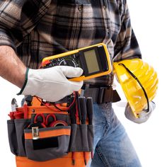 a construction worker holding a tool belt with tools in it's pockets and wearing gloves