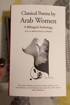 a book about classical poem by arab women is being held in front of a woman's face