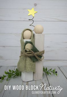 two wooden dolls sitting on top of each other in front of a white background with the words diy wood block nativity written below